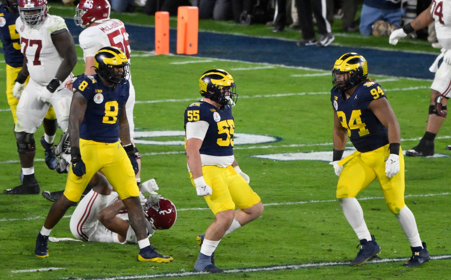 Jan 1, 2024; Pasadena, CA, USA; Michigan Wolverines defensive lineman Mason Graham (55) celebrates tackling Alabama Crimson Tide running back Jase McClellan (2) for a loss in overtime at the Rose Bowl. Left is Michigan Wolverines defensive end Derrick Moore (8), right is Michigan Wolverines defensive lineman Kris Jenkins (94).