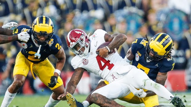Alabama quarterback Jalen Milroe (4) runs against Michigan defensive back Makari Paige (7) during the second half of the Rose Bowl in Pasadena, Calif., on Monday, Jan. 1, 2024.