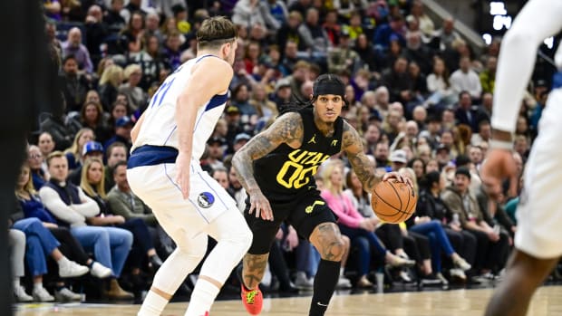 Jan 1, 2024; Salt Lake City, Utah, USA; Utah Jazz guard Jordan Clarkson (00) dribbles around Dallas Mavericks forward/guard Luka Doncic (77) during the second half at the Delta Center.