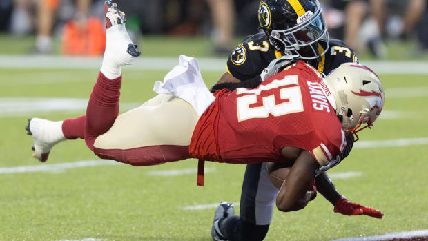 Birmingham Stallions receiver Davion Davis dives in for a first-half touchdown as he is hit by Pittsburgh Maulers defender Eli Walker in the USFL Championship Game at Tom Benson Hall of Fame Stadium, Saturday, July 1, 2023, in Canton.  