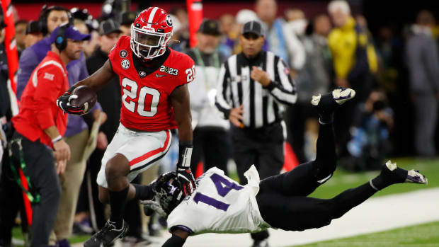 Georgia running back Sevaughn Clark (20) hurdles TCU safety Abraham Camara (14) during the second half of the NCAA College Football National Championship game between TCU and Georgia on Monday, Jan. 9, 2023, in Inglewood, Calif. (Joshua L. Jones / USA TODAY NETWORK).