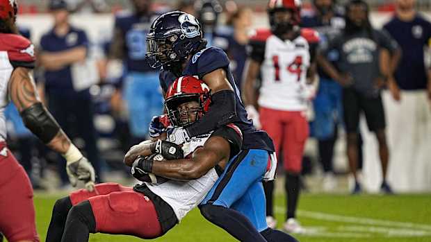 Aug 20, 2022; Toronto, Ontario, CAN; Toronto Argonauts linebacker Wynton McManis (48) tackles Calgary Stampeders running back Dedrick Mills (34) during the second half at BMO Field. Mandatory Credit: John E. Sokolowski-USA TODAY Sports