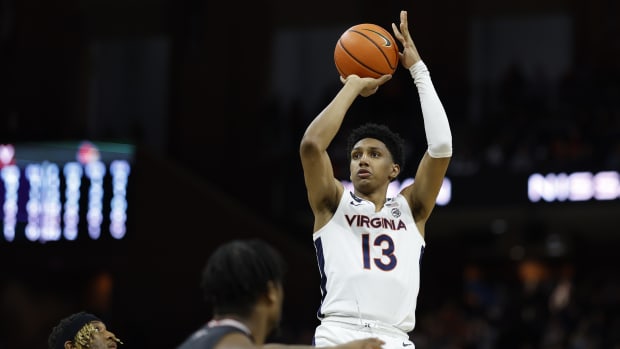 Virginia Cavaliers guard Ryan Dunn (13) shoots the ball over Louisville Cardinals guard El Ellis (3) in the second half at John Paul Jones Arena.