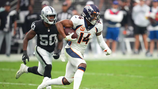 Denver Broncos wide receiver Courtland Sutton (14) runs with the ball ahead of Las Vegas Raiders linebacker Jayon Brown (50) during a game at Allegiant Stadium.