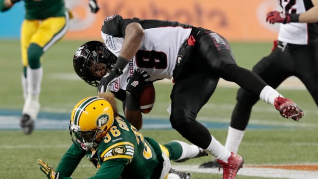 Nov 29, 2015; Winnipeg, Manitoba, CAN; Ottawa Redblacks wide receiver Jake Harty (8) is hit by Edmonton Eskimos defensive back Aaron Grymes (36) in the 4th quarter of the Grey Cup at Investors Group Field. Mandatory Credit: James Carey Lauder-USA TODAY Sports  