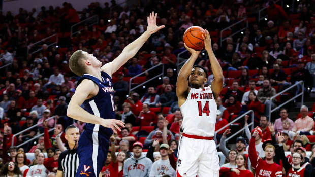 North Carolina State Wolfpack guard Casey Morsell (14) shoots a three pointer during the first half against Virginia Cavaliers at PNC Arena.