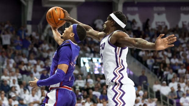 Feb 20, 2023; Fort Worth, Texas, USA; TCU Horned Frogs forward Emanuel Miller (2) blocks the shot of Kansas Jayhawks guard Dajuan Harris Jr. (3) during the second half at Ed and Rae Schollmaier Arena. Mandatory Credit: Kevin Jairaj-USA TODAY Sports  