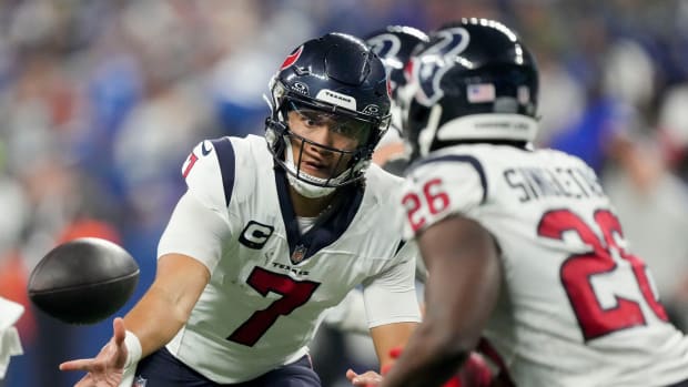 Houston Texans quarterback C.J. Stroud (7) tosses the ball to Houston Texans running back Devin Singletary (26) on Saturday, Jan. 6, 2024, during a game against the Houston Texans at Lucas Oil Stadium in Indianapolis.