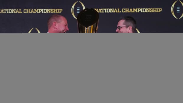 Kalen DeBoer and Jim Harbaugh shake hands after a press conference.