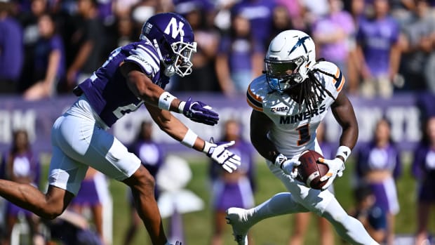 Sep 9, 2023; Evanston, Illinois, USA; University of Texas El Paso Miners wide receiver Tyrin Smith (1) looks for running room after fielding a punt as Northwestern Wildcats defensive back Evan Smith (22) closes in in the first half at Ryan Field. Mandatory Credit: Jamie Sabau-USA TODAY Sports