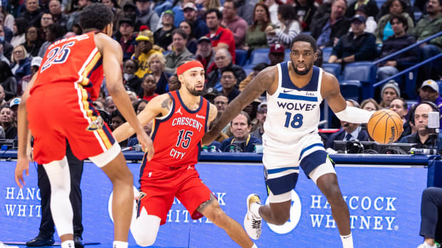 Dec 11, 2023; New Orleans, Louisiana, USA; Minnesota Timberwolves guard Shake Milton (18) dribbles against New Orleans Pelicans guard Jose Alvarado (15) during the first half at the Smoothie King Center.