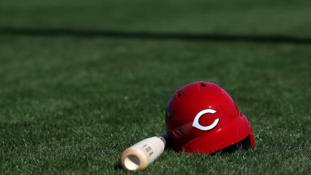 Cincinnati Reds third baseman Eugenio Suarez's (7) bat and helmet rest on the field, Thursday, Feb. 20, 2020, at the baseball team's spring training facility in Goodyear, Ariz. Cincinnati Reds Spring Training 2 20 2020  