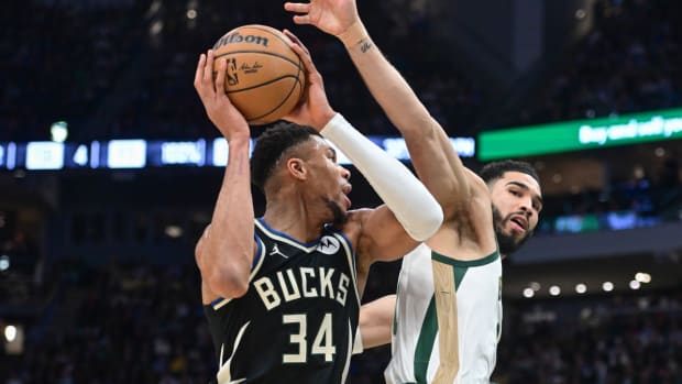 Jan 11, 2024; Milwaukee, Wisconsin, USA; Milwaukee Bucks forward Giannis Antetokounmpo (34) takes a shot against Boston Celtics forward Jayson Tatum (0) in the second quarter at Fiserv Forum. Mandatory Credit: Benny Sieu-USA TODAY Sports  