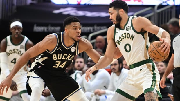 Boston Celtics forward Jayson Tatum (0) drives for the basket against Milwaukee Bucks forward Giannis Antetokounmpo (34) 