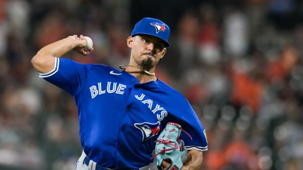 Aug 22, 2023; Baltimore, Maryland, USA; Toronto Blue Jays relief pitcher Jordan Hicks (12) throws a seventh inning pitch against the Baltimore Orioles at Oriole Park at Camden Yards. Mandatory Credit: Tommy Gilligan-USA TODAY Sports