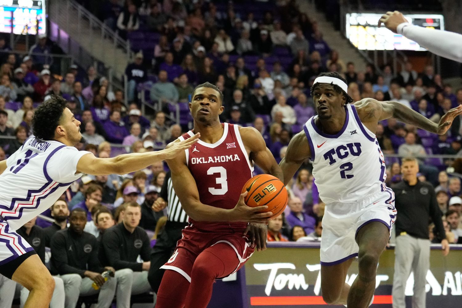 Jan 10, 2024; Fort Worth, Texas, USA; Oklahoma Sooners guard Otega Oweh (3) drives to the basket between TCU Horned Frogs forward Emanuel Miller (2) and guard Trevian Tennyson (11) during the second half at Ed and Rae Schollmaier Arena. 