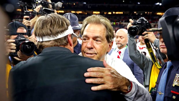 Alabama Crimson Tide head coach Nick Saban and Georgia Bulldogs head coach Kirby Smart shake hands after the 2022 CFP college football national championship game at Lucas Oil Stadium.