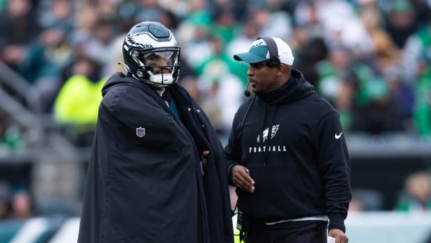 Dec 31, 2023; Philadelphia, Pennsylvania, USA; Philadelphia Eagles quarterback Jalen Hurts (L) and offensive coordinator Brian Johnson (R) talks during a timeout in the second quarter against the Arizona Cardinals at Lincoln Financial Field. Mandatory Credit: Bill Streicher-USA TODAY Sports