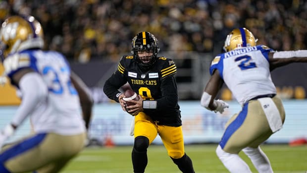 Dec 12, 2021; Hamilton, Ontario, CAN; Hamilton Tiger-Cats quarterback Jeremiah Masoli (8) looks to run as Winnipeg Blue Bombers defensive end Jonathan Kongbo (2) closes in during the 108th Grey Cup football game at Tim Hortons Field. Mandatory Credit: John E. Sokolowski-USA TODAY Sports  