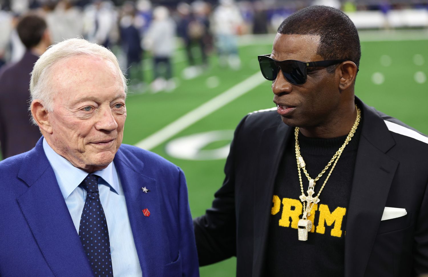 Nov 30, 2023; Arlington, Texas, USA; Colorado Buffaloes head coach Deion Sanders (right) talks with Dallas Cowboys owner Jerry Jones before the game against the Seattle Seahawks at AT&T Stadium