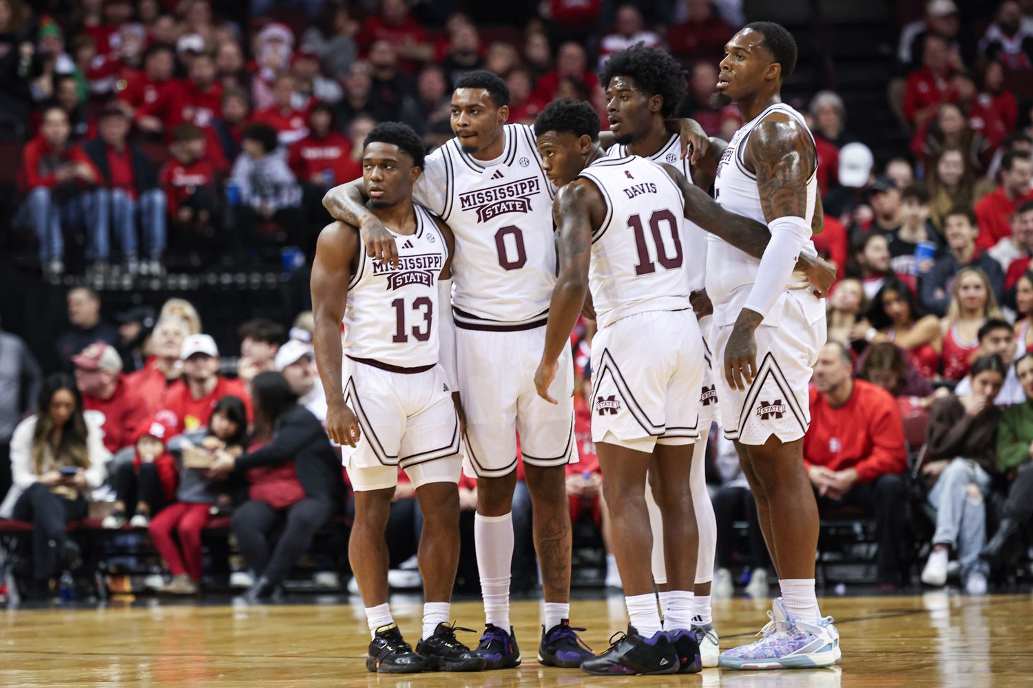 Dec 23, 2023; Newark, NY, USA; Mississippi State Bulldogs guard Josh Hubbard (13) and forward D.J. Jeffries (0) and Bulldogs guard Dashawn Davis (10) huddle with teammates during the first half against the Rutgers Scarlet Knights at Prudential Center. Mandatory Credit: Vincent Carchietta-USA TODAY Sports
