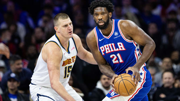 Jan 16, 2024; Philadelphia, Pennsylvania, USA; Philadelphia 76ers center Joel Embiid (21) controls the ball against Denver Nuggets center Nikola Jokic (15) during the first quarter at Wells Fargo Center. Mandatory Credit: Bill Streicher-USA TODAY Sports  