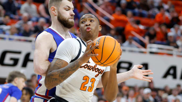 Oklahoma State Cowboys center Brandon Garrison (23) tries to get past Kansas Jayhawks center Hunter Dickinson (1) during a college basketball game between the Oklahoma State University Cowboys (OSU) and the Kansas Jayhawks at Gallagher-Iba Arena in Stillwater, Okla., Tuesday, Jan. 16, 2024.