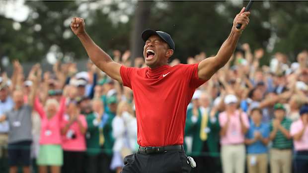 Tiger Woods (L) of the United States celebrates on the 18th green after winning the Masters at Augusta National Golf Club on April 14, 2019 in Augusta, Georgia.
