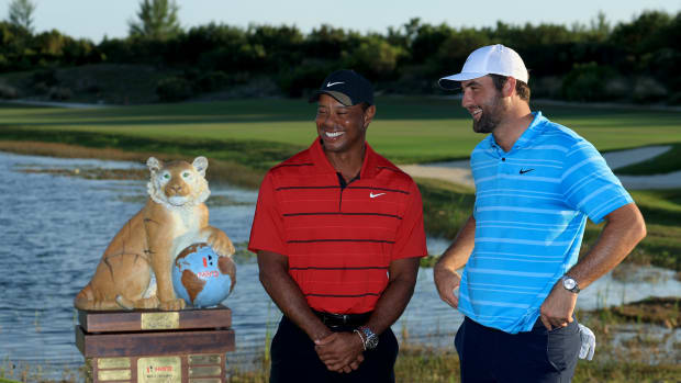 Scottie Scheffler of The United States beside the Hero World Challenge Trophy with tournament host Tiger Woods of The United States after his win in the final round of the Hero World Challenge at Albany Golf Course on December 03, 2023 in Nassau.