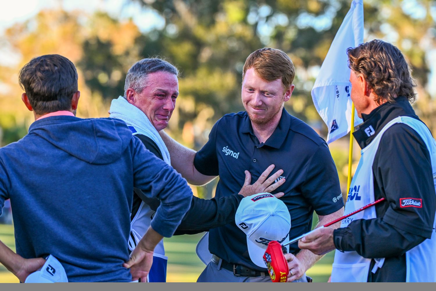 Hayden Springer is emotional with his caddie and family friend on the 18th green during the rain-delayed final round of the PGA TOUR Q-School presented by Korn Ferry tournament on the Dye's Valley Golf Course at TPC Sawgrass on December 18, 2023 in Ponte Vedra Beach, Florida. 