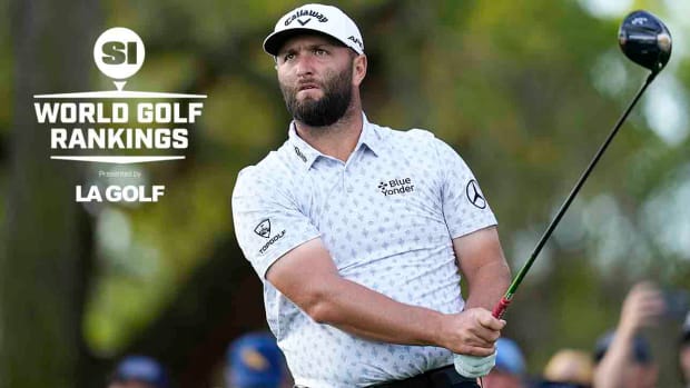 Jon Rahm watches a drive at the 2023 Players Championship along with the SI World Golf Rankings logo.
