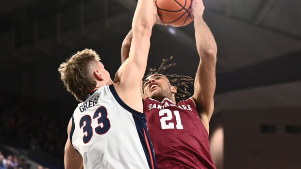 Feb 2, 2023; Spokane, Washington, USA; Santa Clara Broncos forward Camaron Tongue (21) shoots the ball against Gonzaga Bulldogs forward Ben Gregg (33) in the second half at McCarthey Athletic Center. Gonzaga won 88-70.