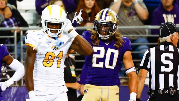 Sep 3, 2022; Seattle, Washington, USA; Washington Huskies safety Asa Turner (20) celebrates after intercepting a pass against Kent State Golden Flashes wide receiver Devontez Walker (81) during the third quarter at Alaska Airlines Field at Husky Stadium. Mandatory Credit: Joe Nicholson-USA TODAY Sports