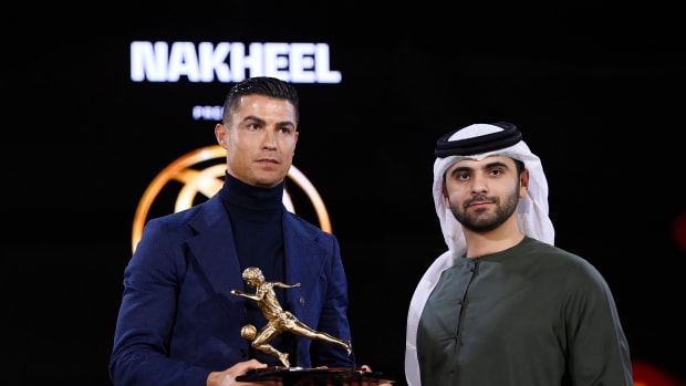 Cristiano Ronaldo pictured (left) collecting a trophy at the 2023 Dubai Globe Soccer Awards in January 2024