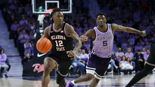 Jan 20, 2024; Manhattan, Kansas, USA; Oklahoma State Cowboys guard Javon Small (12) dribbles by Kansas State Wildcats guard Cam Carter (5) during the second half at Bramlage Coliseum. Mandatory Credit: Scott Sewell-USA TODAY Sports