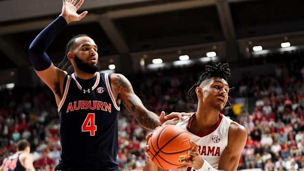 Jan 24, 2024; Tuscaloosa, Alabama, USA; Auburn Tigers center Johni Broome (4) defends Alabama Crimson Tide forward Jarin Stevenson (15) at Coleman Coliseum. Mandatory Credit: Gary Cosby Jr.-USA TODAY Sports  