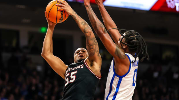 Jan 23, 2024; Columbia, South Carolina, USA; South Carolina Gamecocks guard Ta'Lon Cooper (55) shoots over Kentucky Wildcats guard Rob Dillingham (0) in the first half at Colonial Life Arena. Mandatory Credit: Jeff Blake-USA TODAY Sports