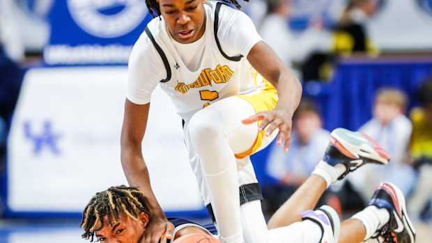 Woodford County point guard Jasper Johnson battles Warren Central guard Damarion Walkup for control of the ball in the second half of Saturday's KHSAA Boys Sweet 16 semifinal. The Yellowjackets fell to the Dragons 56-48. March 18, 2023