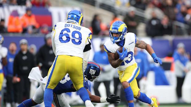 Dec 31, 2023; East Rutherford, New Jersey, USA; Los Angeles Rams running back Kyren Williams (23) scores a rushing touchdown as Los Angeles Rams guard Kevin Dotson (69) blocks New York Giants linebacker Bobby Okereke (58) during the second half at MetLife Stadium.