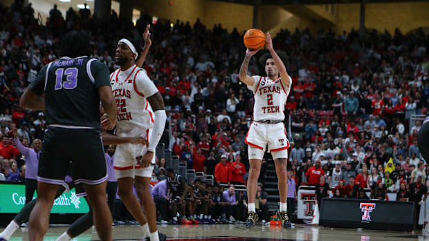 Jan 13, 2024; Lubbock, Texas, USA; Texas Tech Red Raiders guard Pop Isaacs (2) takes a jump shot against Kansas State Wildcats center Will McNair Jr. (13) in the second half at United Supermarkets Arena. Mandatory Credit: Michael C. Johnson-USA TODAY Sports