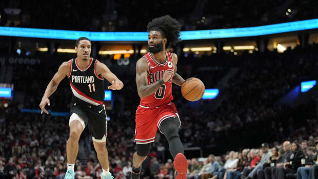 Chicago Bulls point guard Coby White (0) dribbles the ball while defended by Portland Trail Blazers point guard Malcolm Brogdon (11) during the first half at Moda Center.