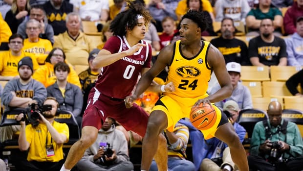 Jan 18, 2023; Columbia, Missouri, USA; Missouri Tigers guard Kobe Brown (24) dribbles the ball against Arkansas Razorbacks guard Anthony Black (0) during the second half at Mizzou Arena. Mandatory Credit: Jay Biggerstaff-USA TODAY Sports
