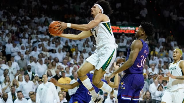Feb 26, 2022; Waco, Texas, USA; Baylor Bears guard Kendall Brown (2) scores a layup against Kansas Jayhawks guard Ochai Agbaji (30) during the second half at Ferrell Center.