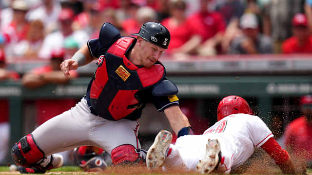 Jun 25, 2023; Cincinnati, Ohio, USA; Atlanta Braves catcher Sean Murphy (12) tags out Cincinnati Reds center fielder TJ Friedl (29) at home plate in the first inning of a baseball game at Great American Ball Park. Mandatory Credit: Kareem Elgazzar-USA TODAY Sports