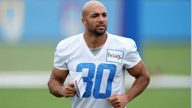 Chargers running back Austin Ekeler jogs without a helmet during practice.