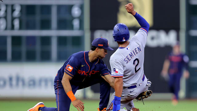 Houston Astros shortstop Jeremy Pena, left, tags out Texas Rangers second baseman Marcus Semien on a stolen base attempt during the fourth inning Monday at Minute Maid Park.