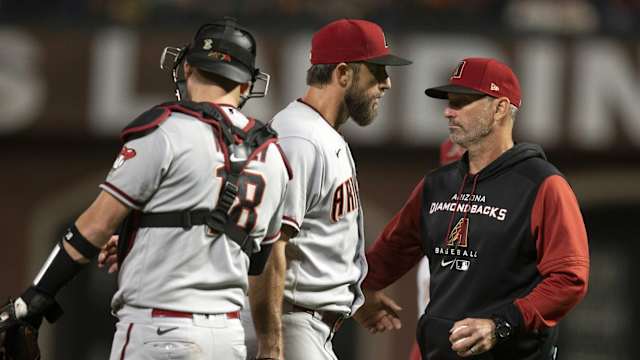 Torey Lovullo takes the ball from Madison Bumgarner.