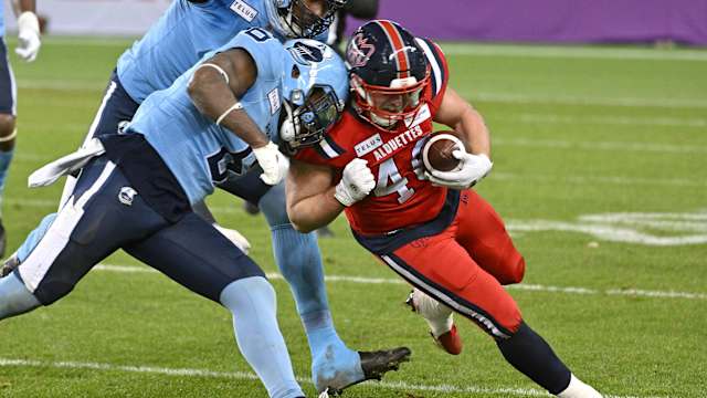 Nov 11, 2023; Toronto, Ontario, CAN; Montreal Alouettes fullback James Tuck (40) is stopped by Toronto Argonauts defensive back Adarius Pickett (6) in the second half at BMO Field. Mandatory Credit: Dan Hamilton-USA TODAY Sports  