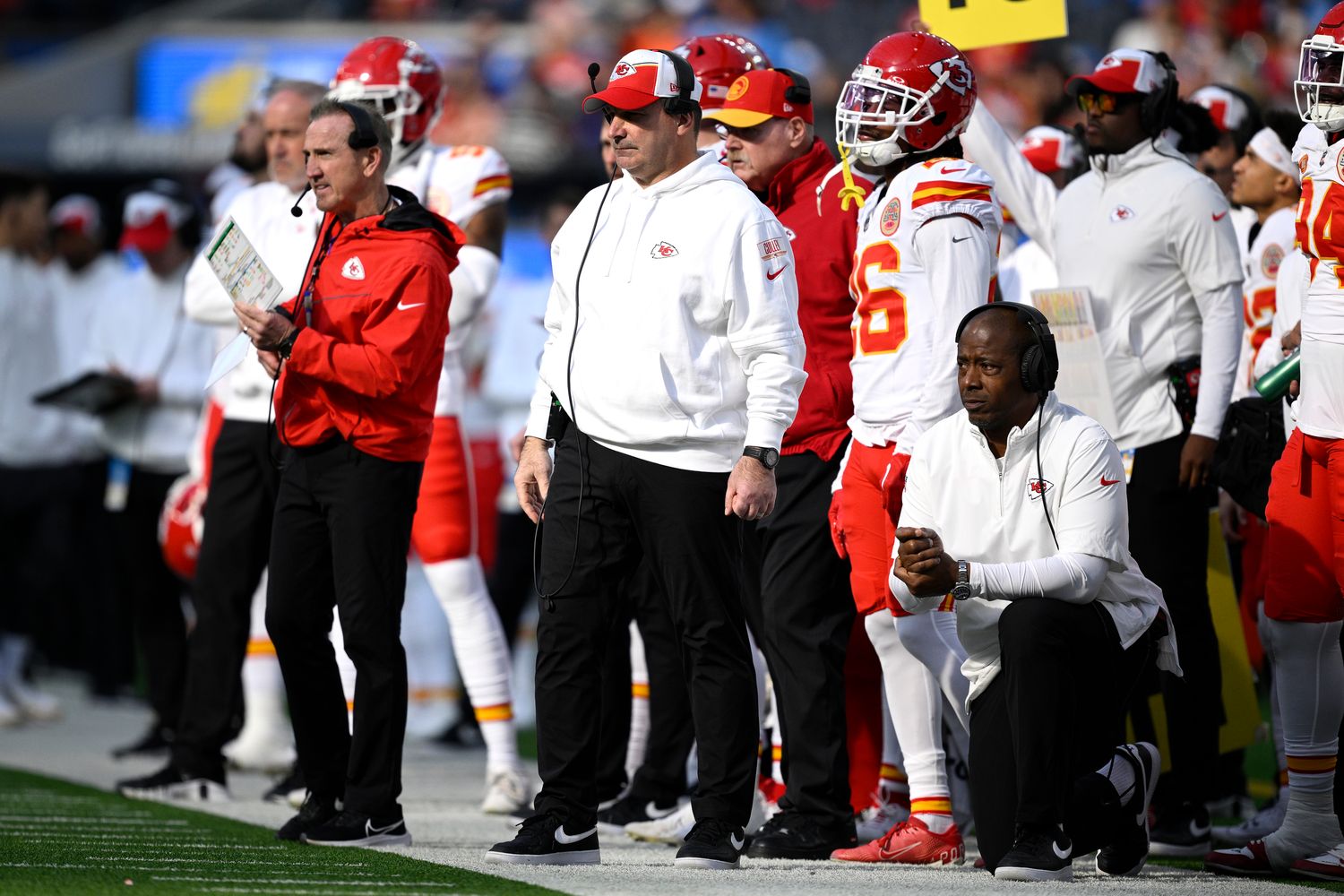 Jan 7, 2024; Inglewood, California, USA; Kansas City Chiefs defensive line coach Joe Cullen (center) looks on from the sideline alongside defensive coordinator Steve Spagnuolo (left) and defensive backs coach Dave Merritt (bottom, right) during the first half against the Los Angeles Chargers at SoFi Stadium. Mandatory Credit: Orlando Ramirez-USA TODAY Sports  