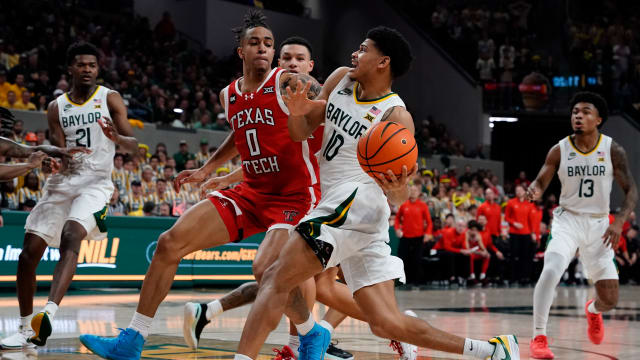 Feb 6, 2024; Waco, Texas, USA; Baylor Bears guard RayJ Dennis (10) drives on Texas Tech Red Raiders guard Chance McMillian (0) during the second half at Paul and Alejandra Foster Pavilion. 